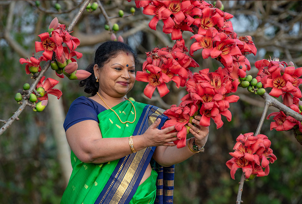 Dr. Neela standing amid flowers