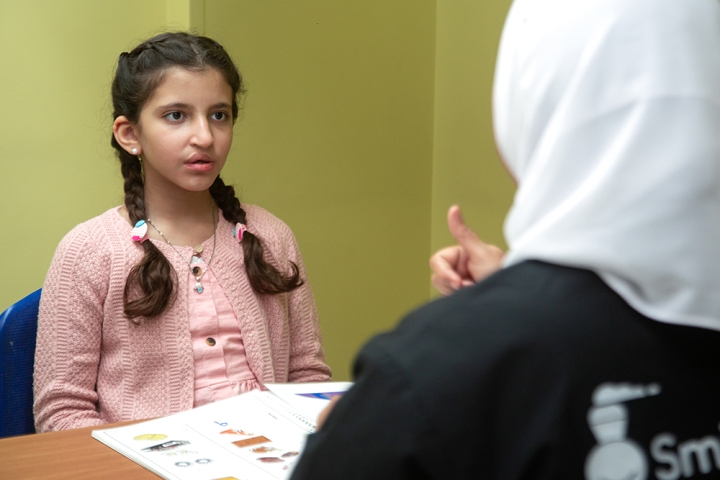 teacher giving girl speech lessons