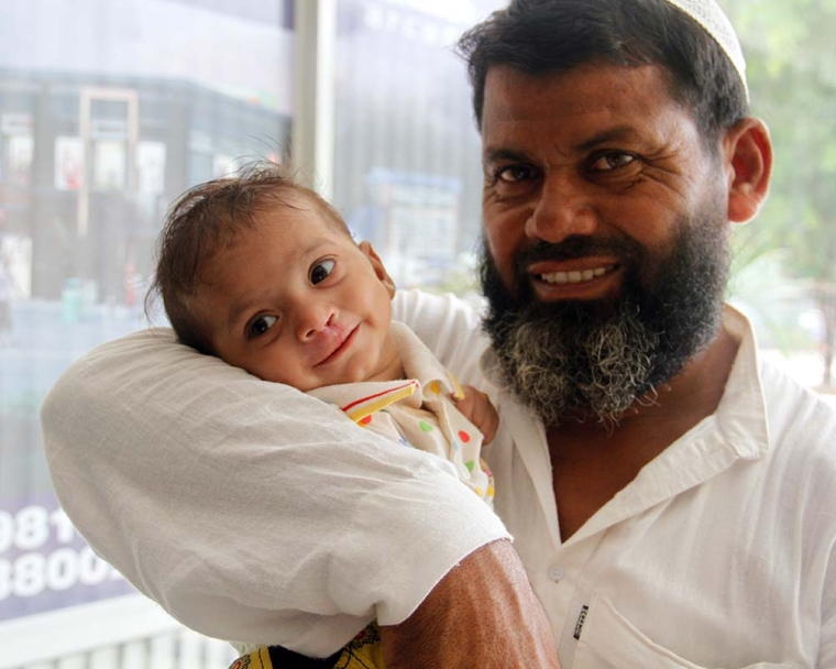 Dad holds baby 